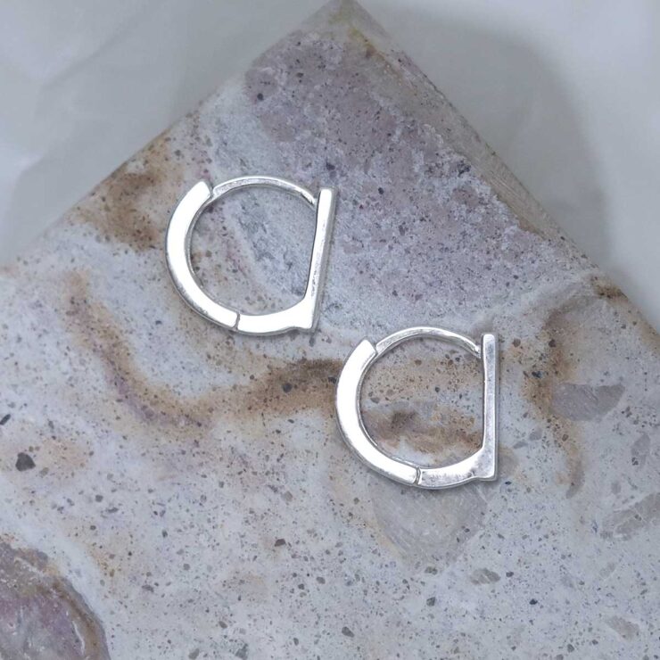 Sterling Silver Straight Edge Huggies on stone