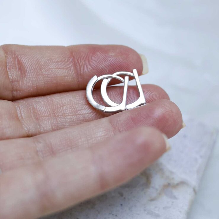 Sterling Silver Straight Edge Huggies in models hand