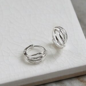 Polished sterling silver braided huggies/ hinged hoop earrings on white background showing front and side.