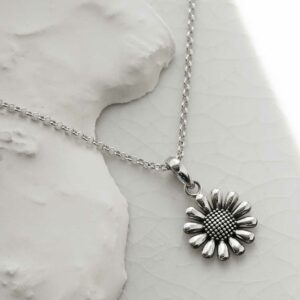 Sterling Silver oxidised daisy pendant necklace on a white backgound