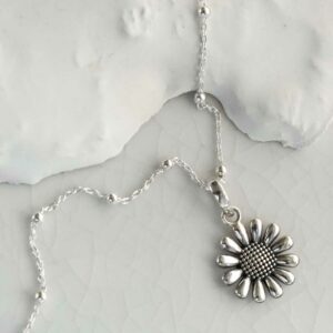 Sterling Silver oxidised daisy pendant necklace on a white backgound