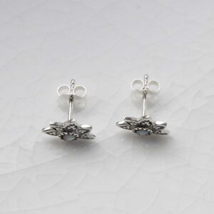 Pearl lotus studs on white background