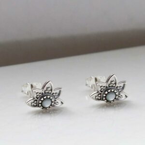 Pearl lotus studs on white background with shadow