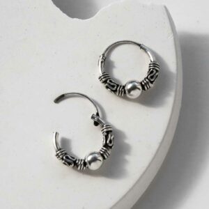 Silver Indo hoops, one open on white background with deep shadows