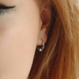 Silver Indo hoops on model with red hair