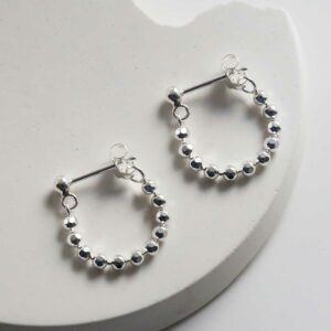 Silver Swinging bead studs on white background