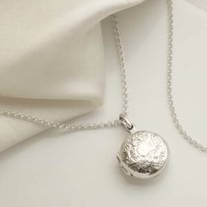 Sterling Silver Decorative Round Locket on silk background