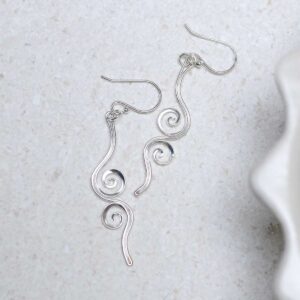 Sterling Silver Reflected Twirl Dangly Earrings on stone