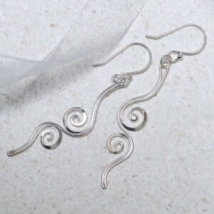 Sterling Silver Reflected Twirl Dangly Earrings on stone