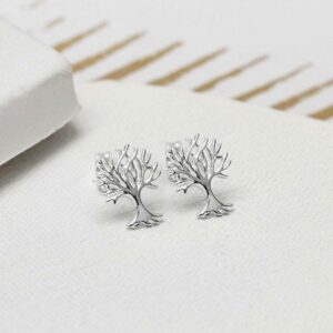 Silver Tree stud earrings on white ceramic background with gold detail paper