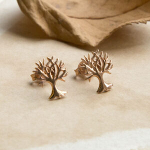 Rose Gold Tree studs on warm tone paper with autumn leaves in background