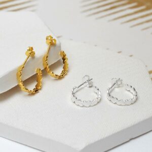 Gold and silver love hoops together on white ceramic tiles with gold detail background