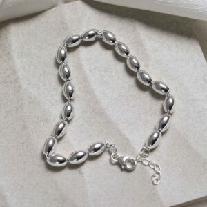 Sterling Silver Oval Beads Bracelet on stone background