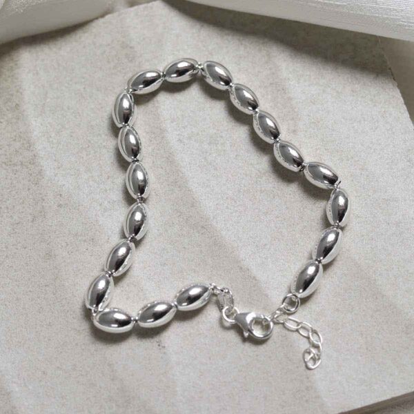 Sterling Silver Oval Beads Bracelet on stone background