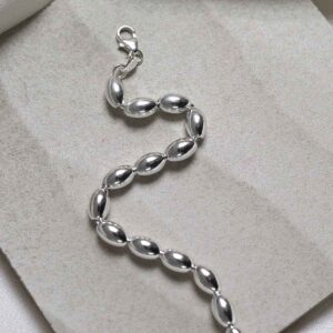 Sterling Silver Oval Beads Bracelet on stone background