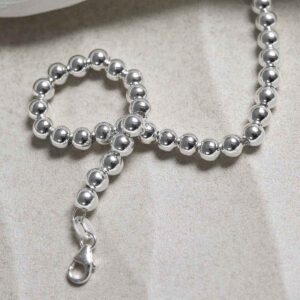 Sterling Silver Round Beads Bracelet on stone background