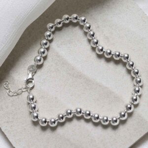 Sterling Silver Round Beads Bracelet on stone background