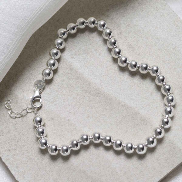 Sterling Silver Round Beads Bracelet on stone background