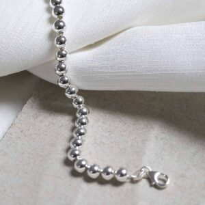 Sterling Silver Round Beads Bracelet on stone background