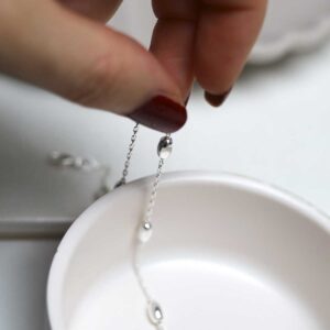 model holding Sterling Silver Dew Drop Anklet