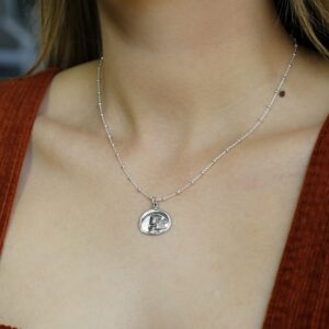 woman wearing silver ancient persian coin pendant necklace