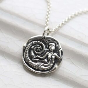 Sterling Silver Siren Necklace on ceramic