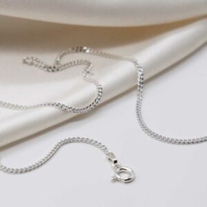 sterling silver medium curb chain strewn on linen