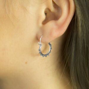 Silver and Oxidised Hoops with circular ball detail pattern on Brunette Model