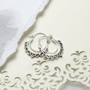 Sterling Silver Persian Waves Hoops on cream paper with ripped and pattern detail