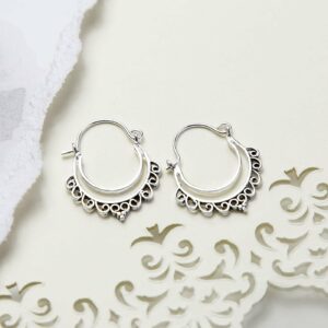 Sterling Silver Persian Waves Hoops on cream paper with ripped and pattern detail