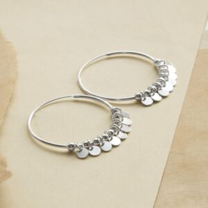 Silver Hoops with sequin detail on different coloured sandy paper background