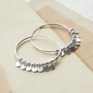 Silver Hoops with sequin detail on different coloured sandy paper background