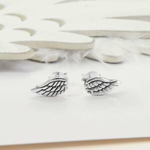 Small Silver Angel Wing Studs with white feather and wooden feather background