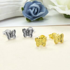 Small Silver Butterfly studs on the left and Small Gold Butterfly studs on the right with Blue and white roses in the background