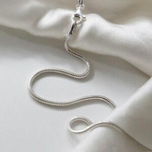 sterling silver heavy snake chain strewn on linen