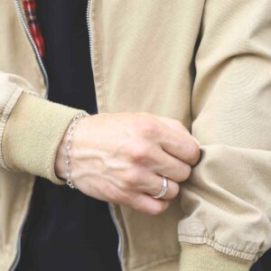 silver plain band ring on male model with beige jacket