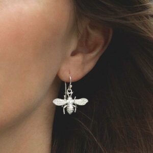 model wearing sterling silver dangly bee earrings