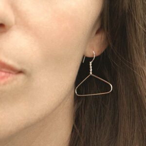 model wearing sterling silver coat hanger earrings