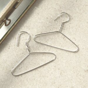 sterling silver coat hanger earrings laid out