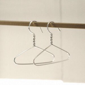 sterling silver coat hanger earrings hung on rail