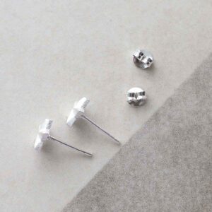 Sterling Silver Solid Star Stud Earrings on ceramic background