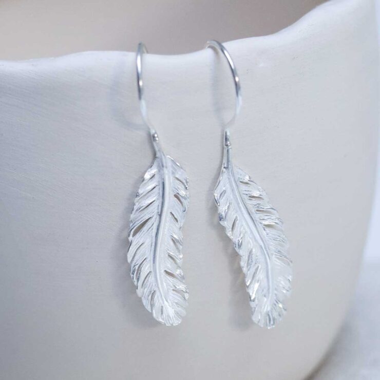 Sterling Silver Feather Drop Earrings on cup