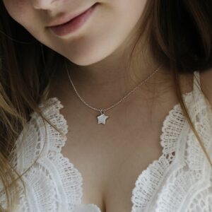 Sterling Silver Polished Star Necklace Hanging round a girls neck