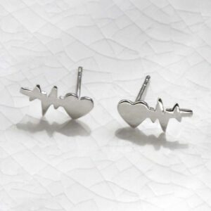 Sterling Silver Heart Wave Studs sat on marble with a shadow being cast.