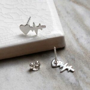 Sterling Silver Heart Wave Studs sat on marble with a shadow being cast.