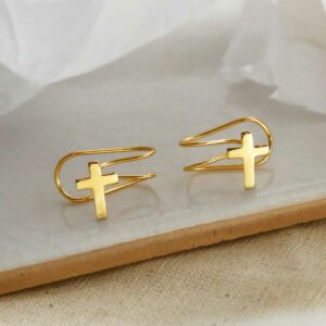 gold plated cross ear cuff on a marble slab