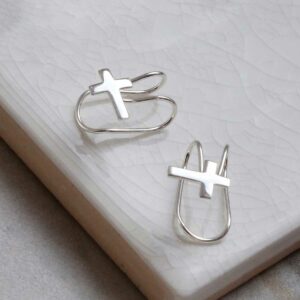 Sterling silver cross ear cuff on a marble slab