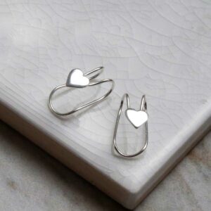 Sterling Silver Heart Ear Cuffs on a white marble tile