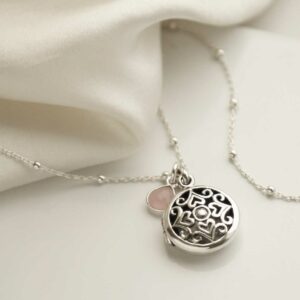 Sterling Silver Vintage Round Locket, satellite chain and add on charms on cream background silk detail