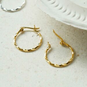 Gold plated Sterling Silver Twisted Hoops on a white granite background